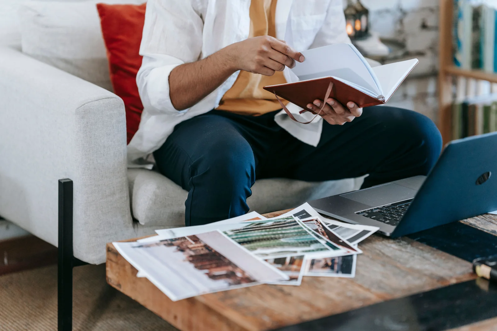Designer concentrating on a laptop and printed work